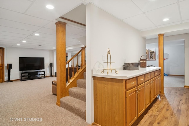 kitchen with recessed lighting, decorative columns, a paneled ceiling, and light countertops