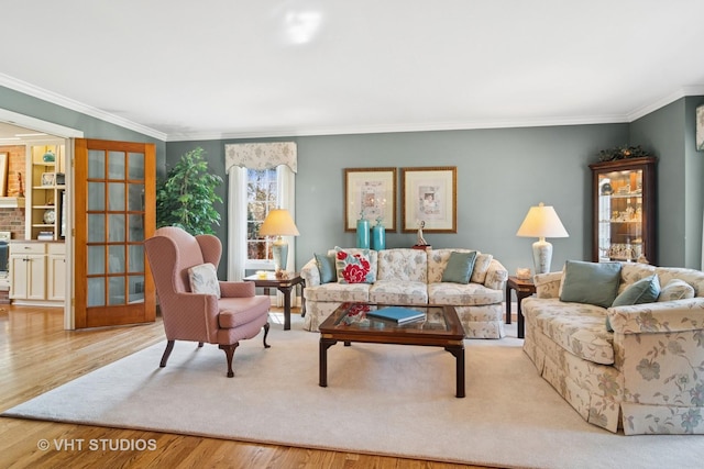 living area with wood finished floors and crown molding