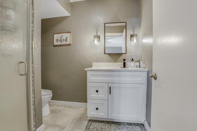 bathroom with baseboards, a textured wall, toilet, tile patterned floors, and vanity