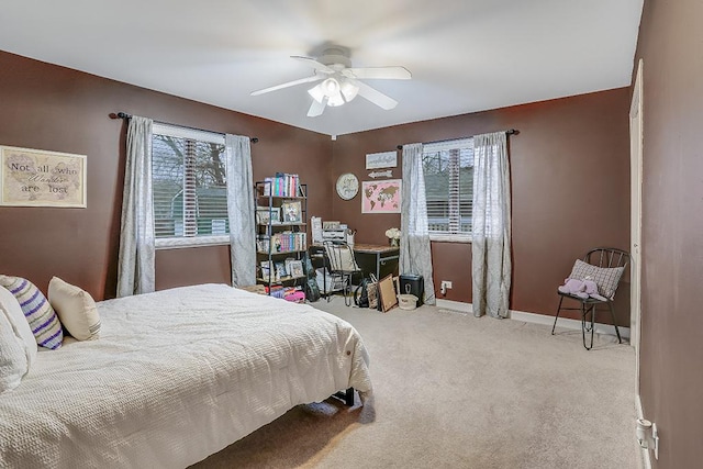 carpeted bedroom featuring a ceiling fan and baseboards