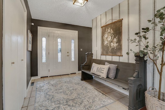 entrance foyer featuring light tile patterned floors and a textured ceiling