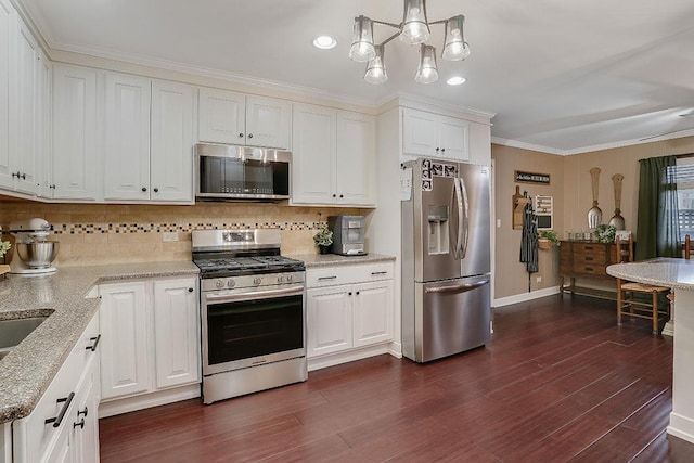 kitchen featuring stainless steel appliances, dark wood finished floors, and white cabinetry