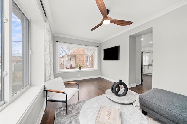 sitting room featuring baseboards, ornamental molding, ceiling fan, and wood finished floors