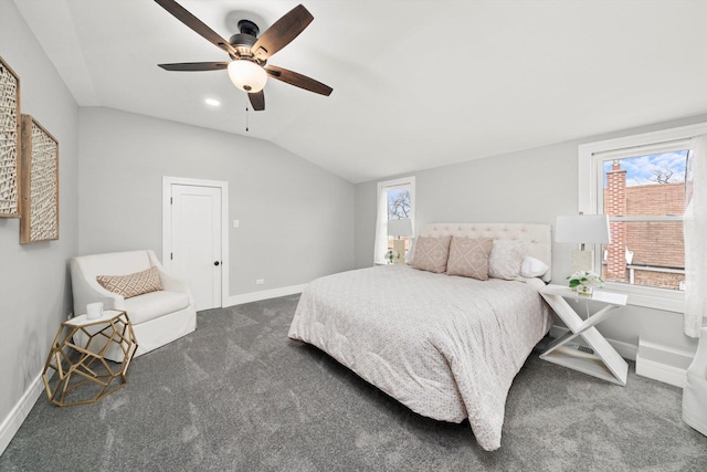 bedroom with vaulted ceiling, multiple windows, carpet, and baseboards