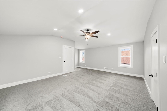 carpeted empty room featuring baseboards, vaulted ceiling, a ceiling fan, and recessed lighting