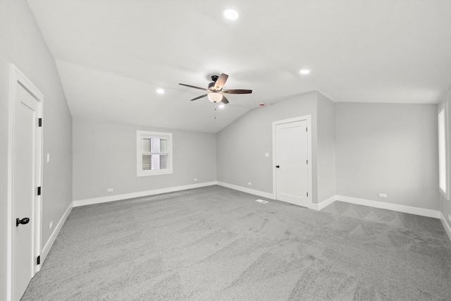 additional living space with lofted ceiling, carpet flooring, ceiling fan, and baseboards