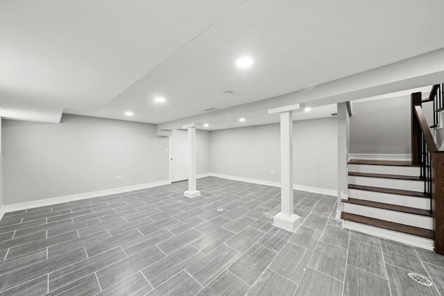 finished below grade area with wood finish floors, stairway, recessed lighting, and baseboards