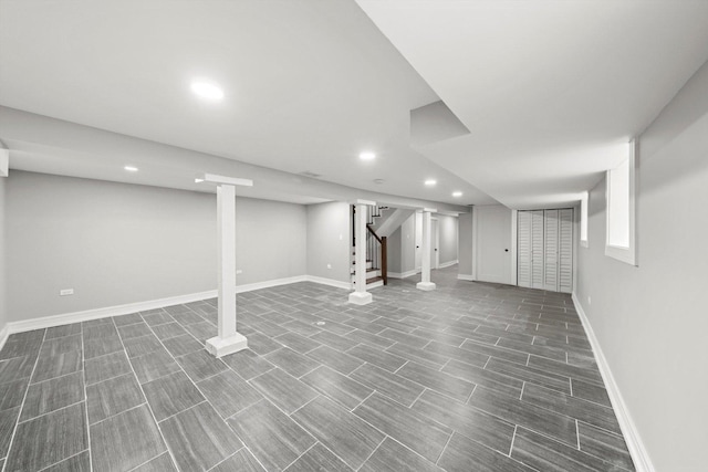 finished below grade area featuring recessed lighting, baseboards, and stairs