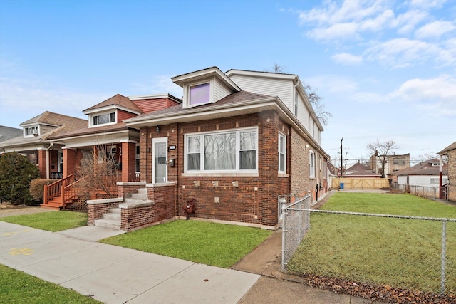 view of front of house featuring a gate, fence, a front lawn, and brick siding