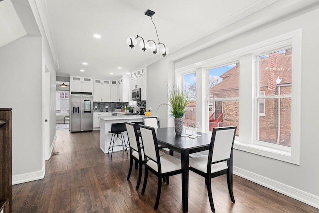 dining room with a chandelier, recessed lighting, dark wood finished floors, and baseboards