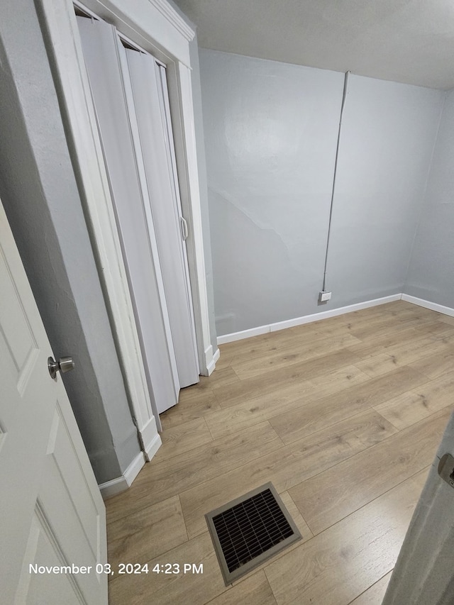 interior space featuring visible vents, baseboards, and wood finished floors