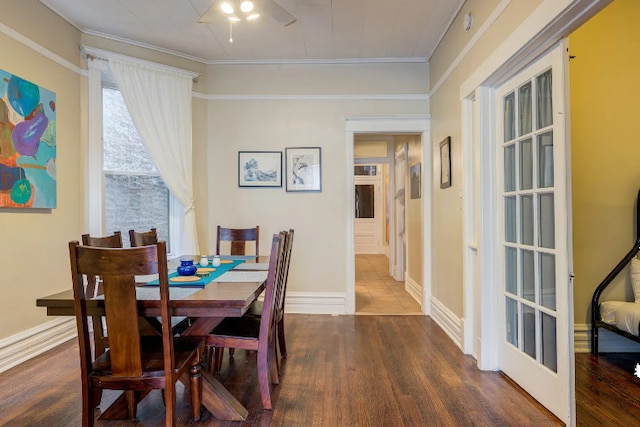 dining area with baseboards, wood finished floors, and ornamental molding