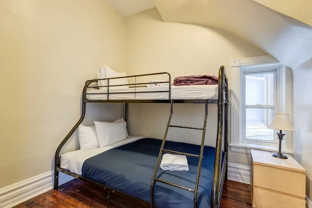 bedroom featuring baseboards and wood finished floors