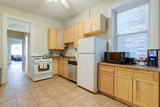 kitchen featuring white appliances, ceiling fan, a sink, and light brown cabinetry