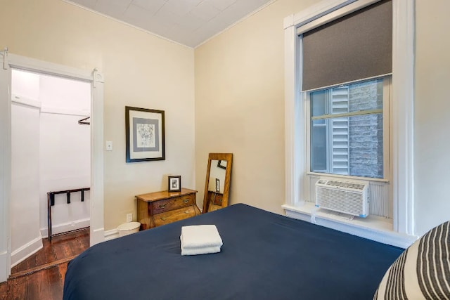 bedroom with baseboards, crown molding, cooling unit, and wood finished floors