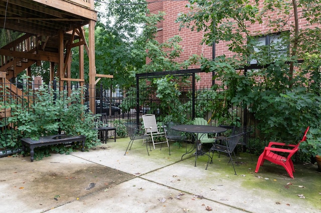 view of patio / terrace featuring stairs and fence