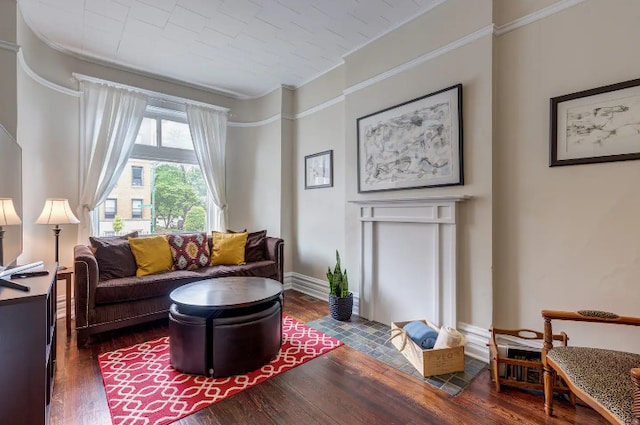 living room with crown molding, dark wood finished floors, and baseboards