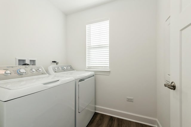 washroom featuring laundry area, baseboards, washer and clothes dryer, and dark wood-type flooring