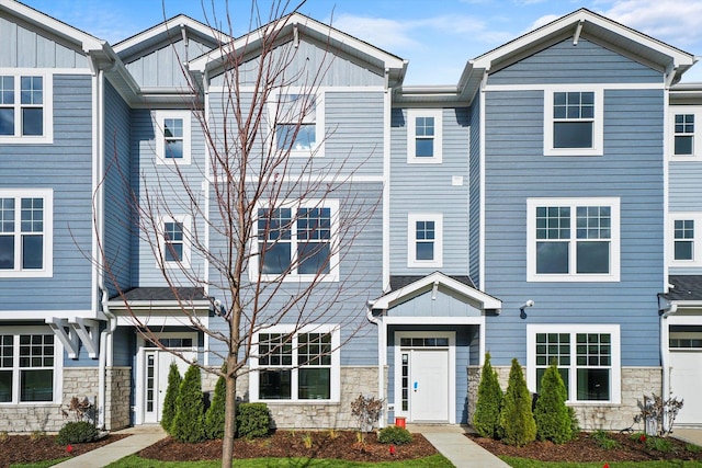 townhome / multi-family property with stone siding and board and batten siding