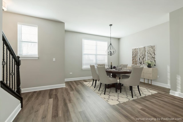 124 E Main St Unit 2-3, Cary, IL 60013 - dining room featuring wood finished floors, a chandelier, and baseboards