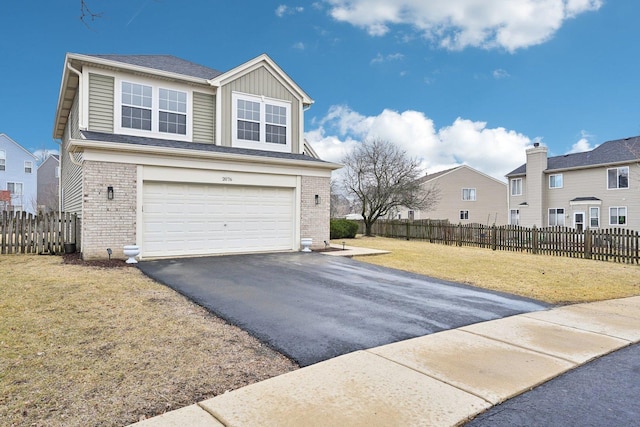 view of front of house with aphalt driveway, brick siding, an attached garage, a front yard, and fence