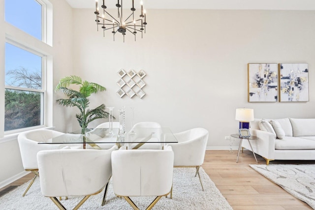 dining area with a healthy amount of sunlight, baseboards, visible vents, and wood finished floors