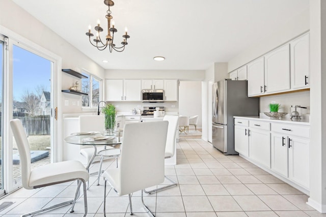 dining space featuring light tile patterned floors, recessed lighting, and an inviting chandelier