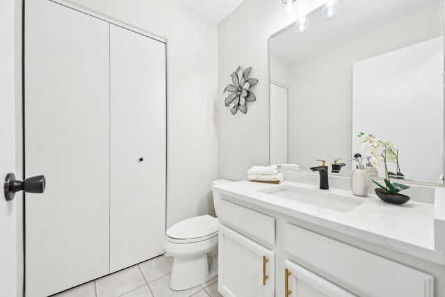 bathroom featuring vanity, tile patterned flooring, and toilet