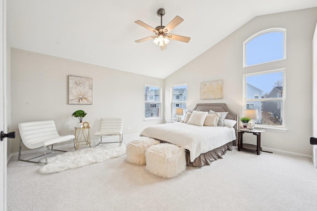 carpeted bedroom with high vaulted ceiling, baseboards, and a ceiling fan