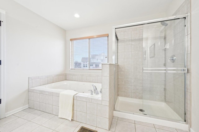 bathroom featuring a stall shower, tile patterned flooring, visible vents, and a garden tub