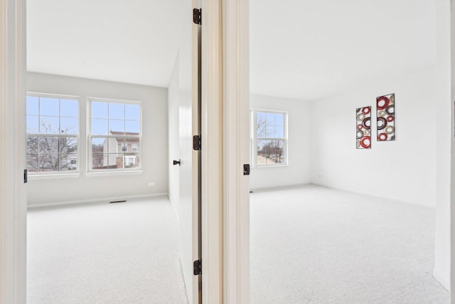 hallway with carpet floors and visible vents