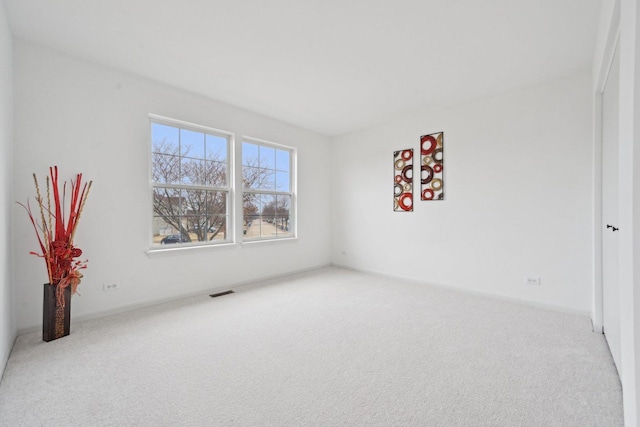 carpeted spare room with visible vents