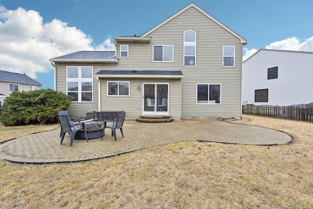 back of house with a fire pit, a lawn, a patio area, and fence