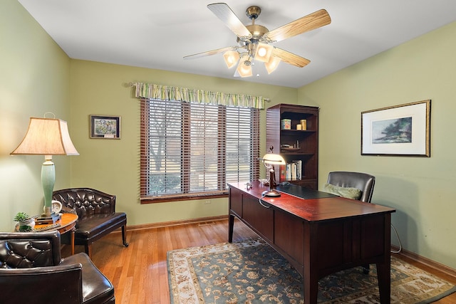 office featuring ceiling fan, baseboards, and wood finished floors