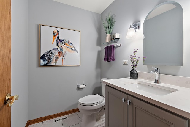 half bathroom featuring tile patterned flooring, toilet, vanity, visible vents, and baseboards