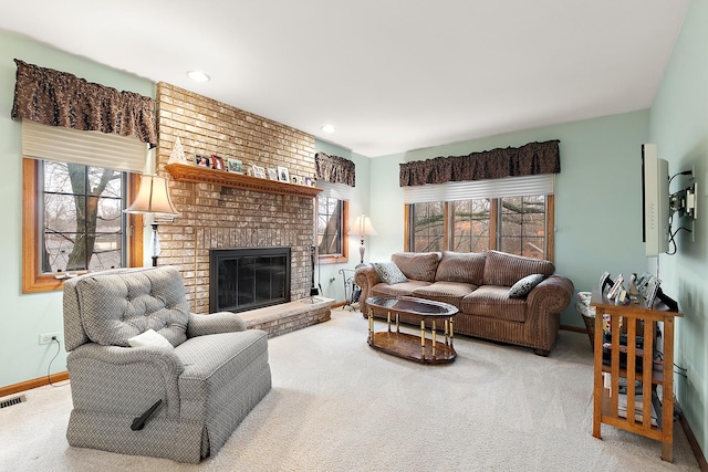 living area with a healthy amount of sunlight, baseboards, a fireplace, and visible vents