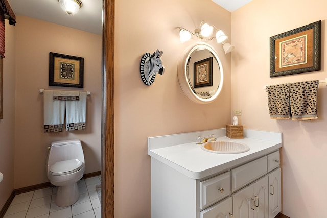 bathroom featuring toilet, vanity, baseboards, and tile patterned floors