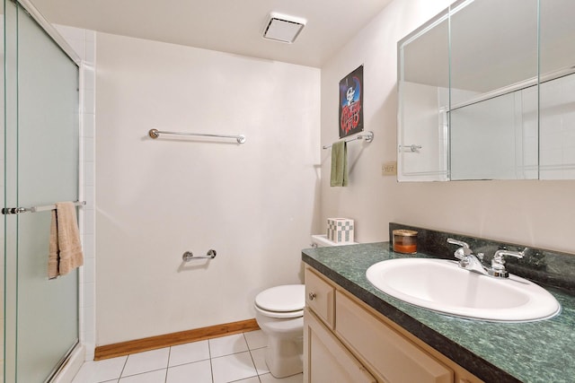 full bathroom featuring toilet, vanity, a shower stall, baseboards, and tile patterned floors