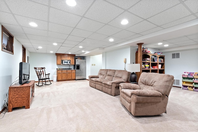 living area featuring recessed lighting, visible vents, and light colored carpet