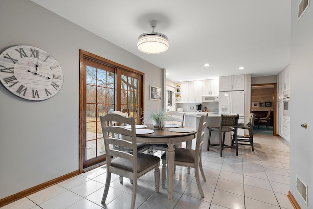 dining space with light tile patterned floors, baseboards, and visible vents