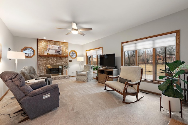 living room featuring visible vents, baseboards, a ceiling fan, a brick fireplace, and carpet