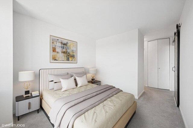 bedroom with light carpet, baseboards, and a barn door