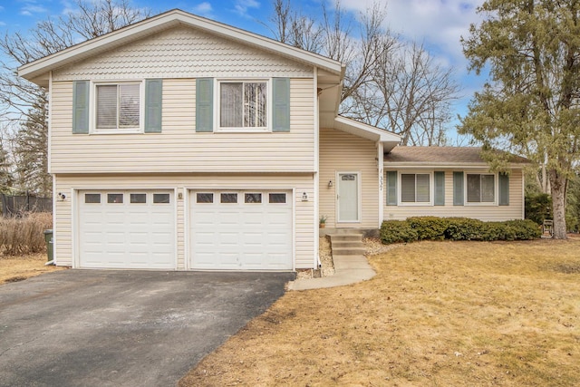 split level home with a garage, driveway, and a front yard