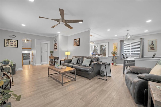 living area featuring baseboards, recessed lighting, light wood-style flooring, and crown molding