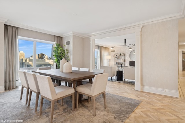 dining space with visible vents, baseboards, a city view, and crown molding