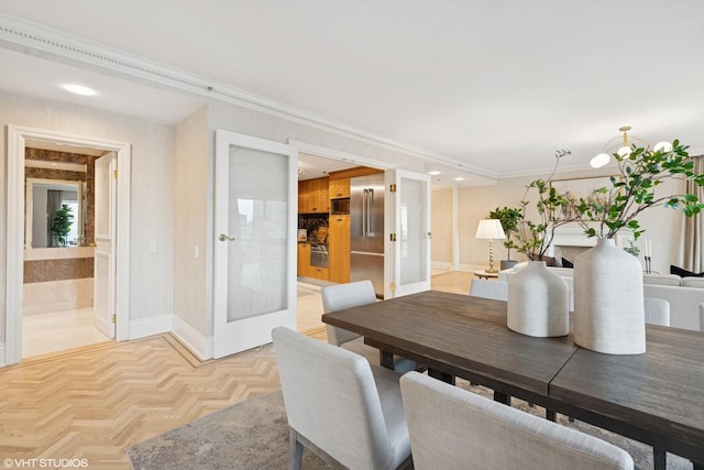 dining space featuring baseboards and crown molding