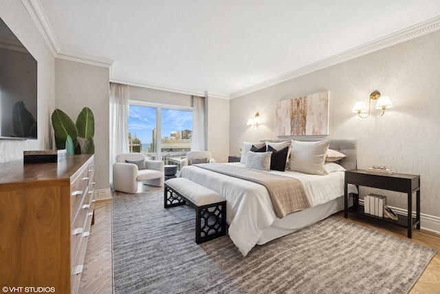 bedroom with ornamental molding, a city view, baseboards, and wood finished floors