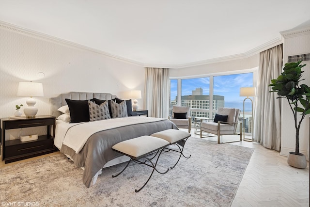 bedroom with access to outside, ornamental molding, and a city view