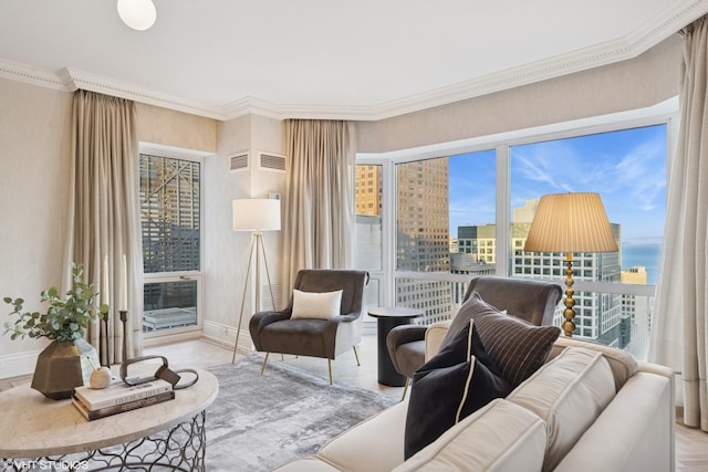 interior space featuring a city view, ornamental molding, visible vents, and baseboards