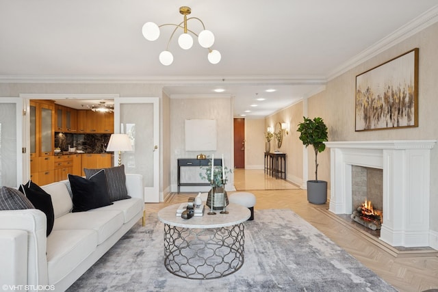 living area with a fireplace with flush hearth, crown molding, baseboards, and an inviting chandelier